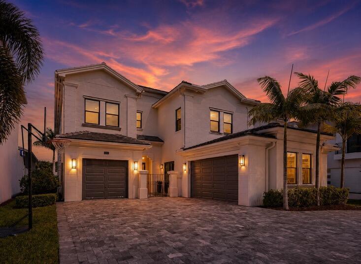 A two-story house with a paved driveway, two garages, and palm trees at sunset — 9065 Benedetta Place, Boca Raton FL 33496, BOCA RATON, FL