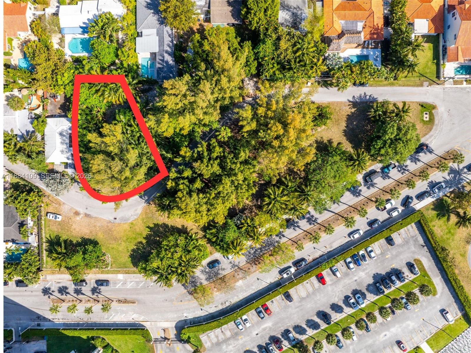This aerial view shows a wooded lot outlined in red next to a parking lot — 891 NE 70th St, Miami FL 33138, MIAMI, FL