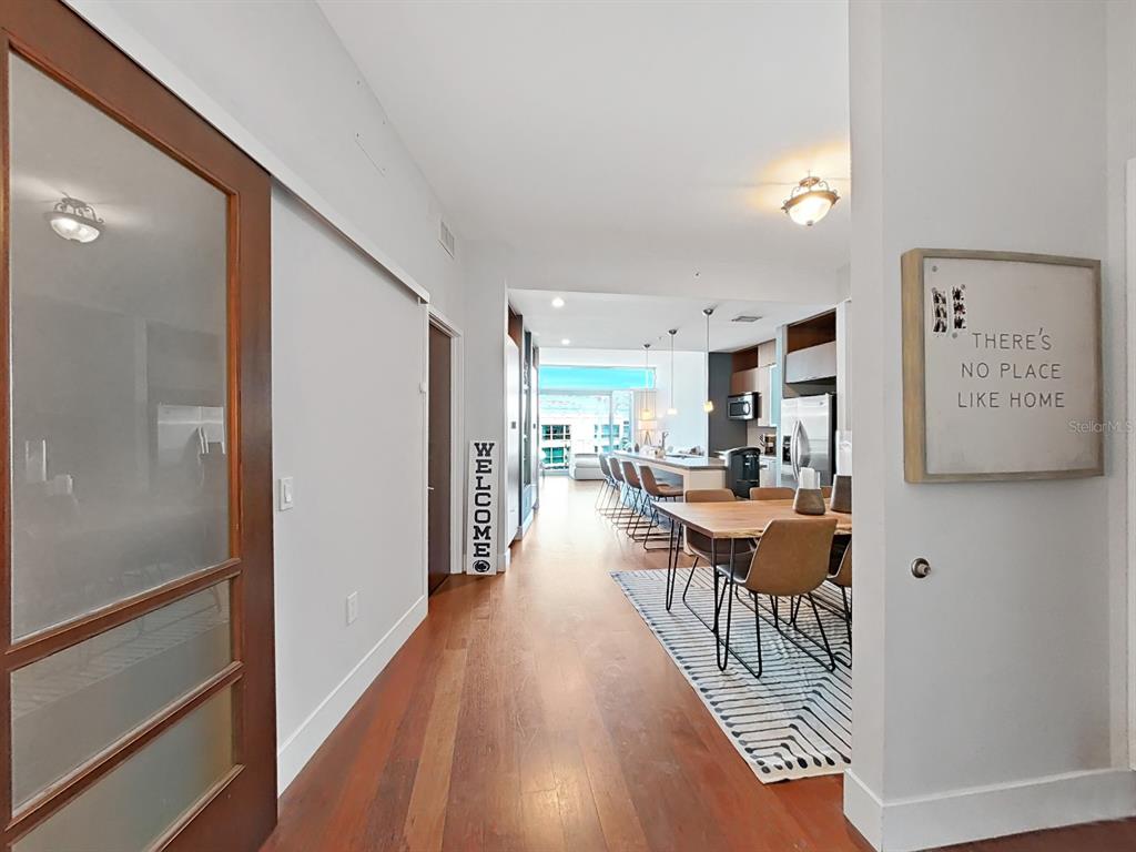 A view from a hallway looking into an open-concept dining area and kitchen — 111 N 12TH STREET UNIT 1810, TAMPA, FL