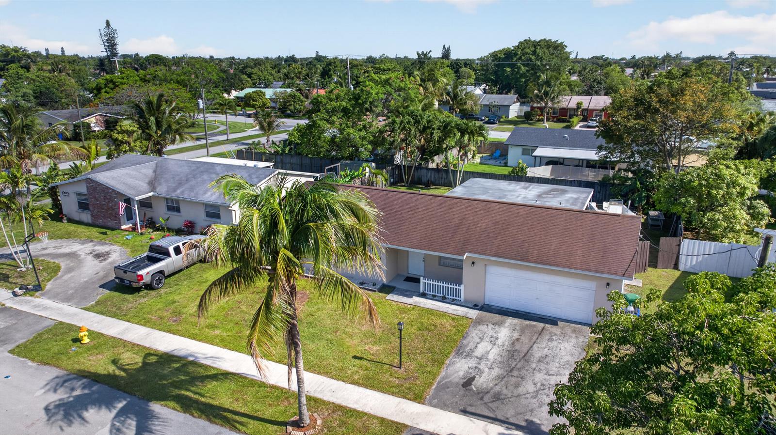 An aerial view shows two single-story suburban houses with driveways, lawns, and palm trees — 6720 NW 26th Street, Margate FL 33063, MARGATE, FL