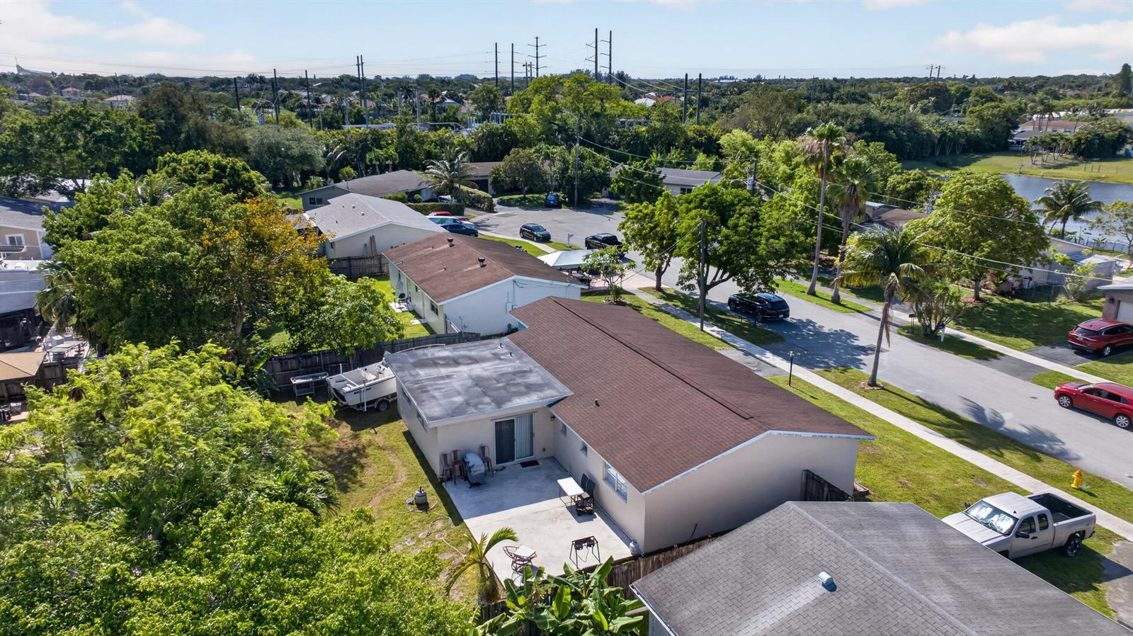 An aerial view shows a residential house with a brown roof and a concrete patio — 6720 NW 26th Street, Margate FL 33063, MARGATE, FL