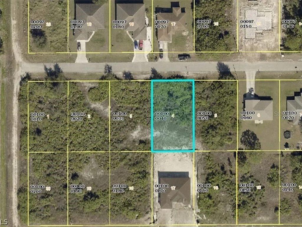 This is an aerial map showing a vacant rectangular lot highlighted in blue among other parcels — 2613 3RD STREET SW, LEHIGH ACRES, FL