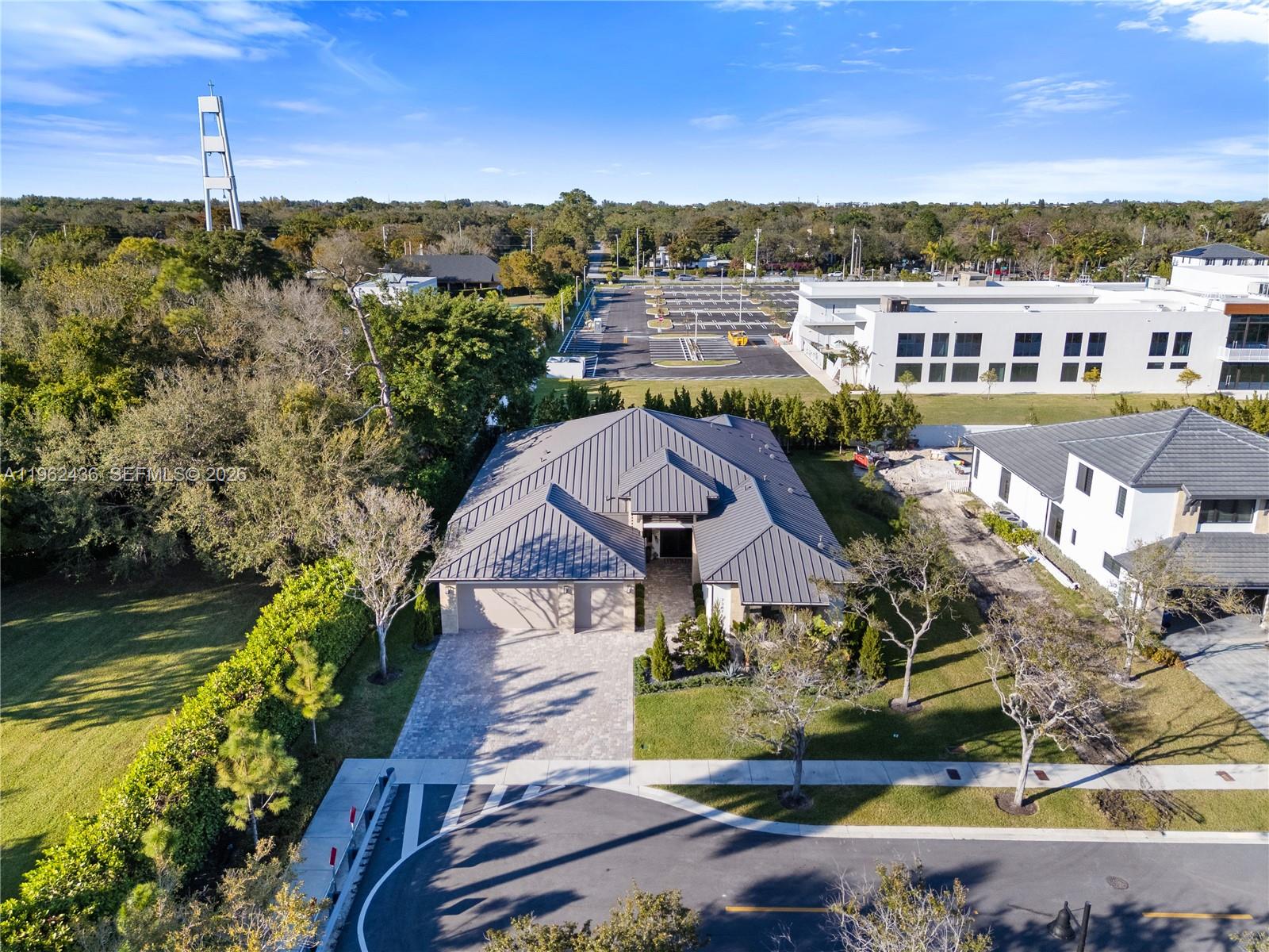 An aerial view shows a modern house with a metal roof and a paved driveway — 7387 SW 74th Ln, Miami FL 33143, MIAMI, FL