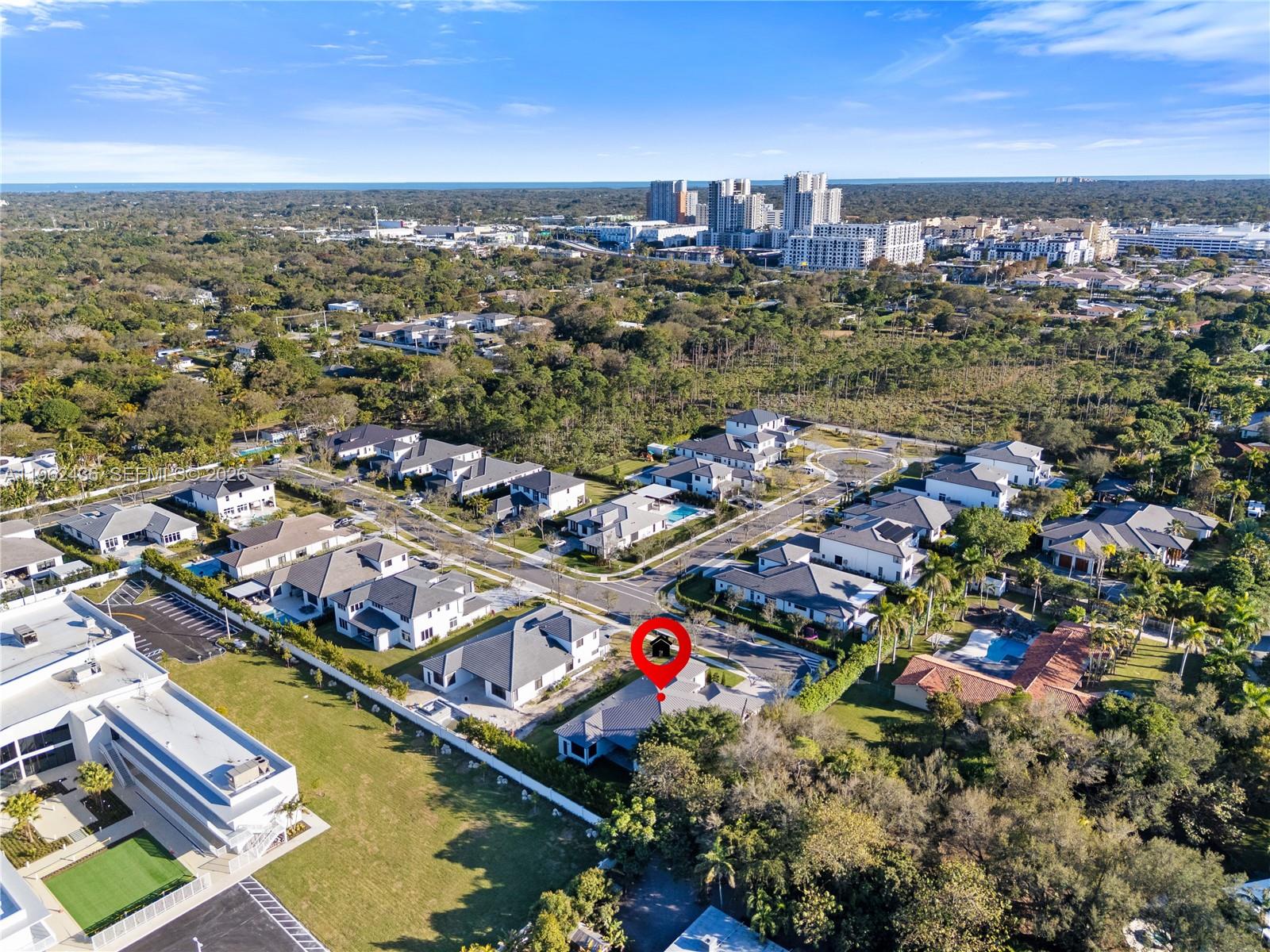 An aerial view shows a residential neighborhood with a red location pin on a house — 7387 SW 74th Ln, Miami FL 33143, MIAMI, FL
