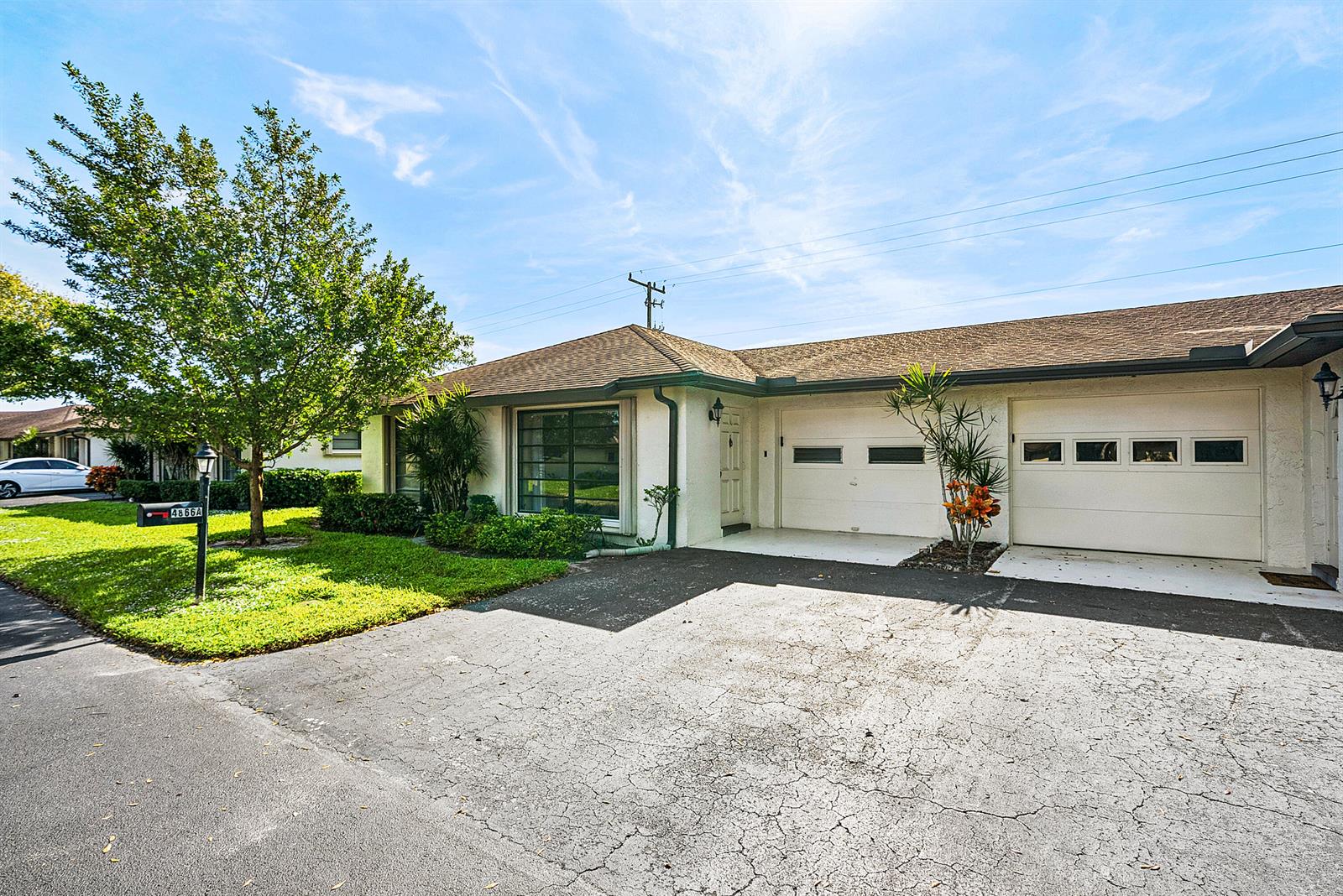 A single-story house with a white stucco exterior, two garage doors, and a front lawn — 4866 Equestrian Road # A, Boynton Beach FL 33436, BOYNTON BEACH, FL