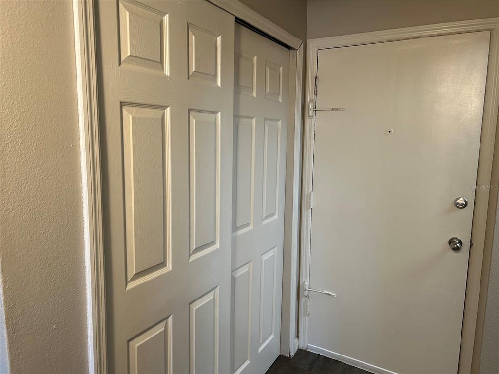 A view of a white interior door next to a white sliding closet door — 1695 LEE ROAD UNIT A103, WINTER PARK, FL