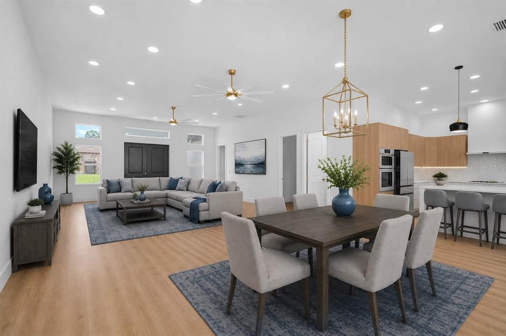 An open-concept living and dining area features light wood floors, recessed lighting, and modern furniture — 4443 WINDSONG AVENUE, NORTH PORT, FL