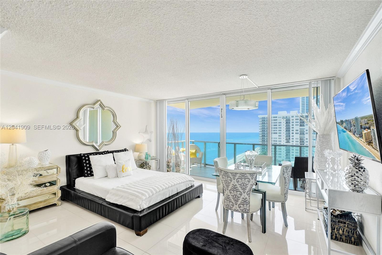A studio apartment features a bed, dining area, and balcony overlooking the ocean — 2501 S Ocean Dr, Hollywood FL 33019, HOLLYWOOD, FL
