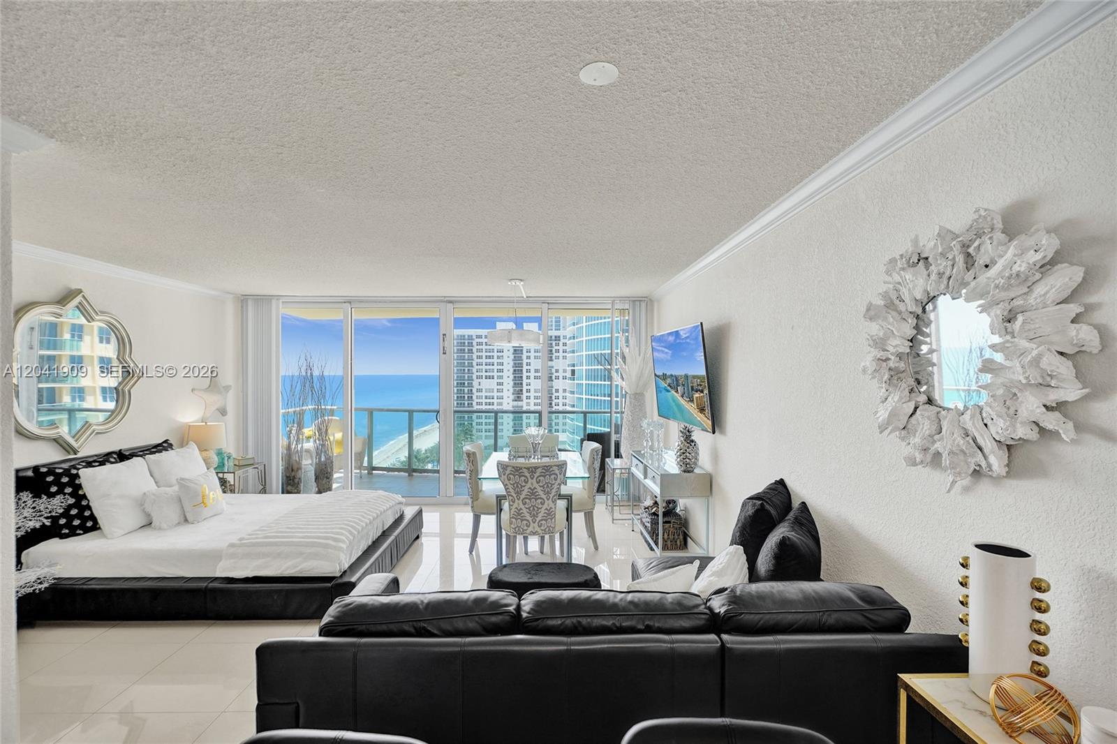 A studio apartment features a bed, living area, dining set, and a balcony overlooking the ocean — 2501 S Ocean Dr, Hollywood FL 33019, HOLLYWOOD, FL
