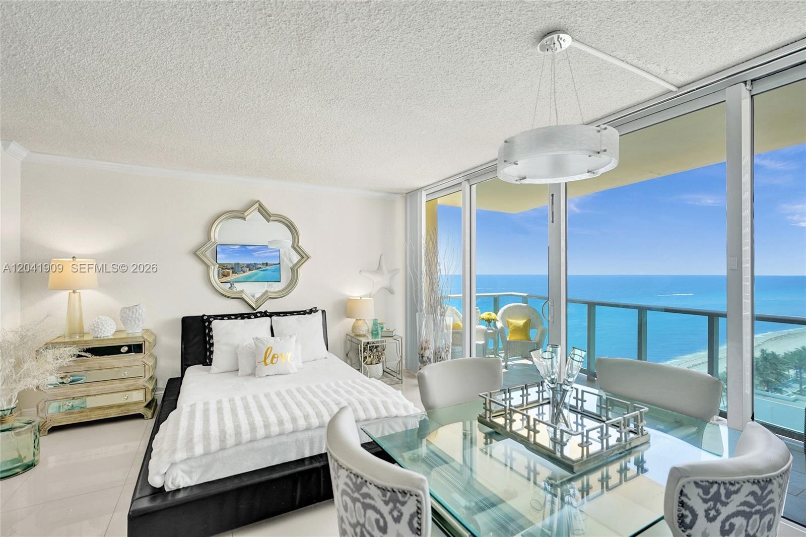 A studio apartment features a bed, dining area, and balcony with a direct ocean view — 2501 S Ocean Dr, Hollywood FL 33019, HOLLYWOOD, FL