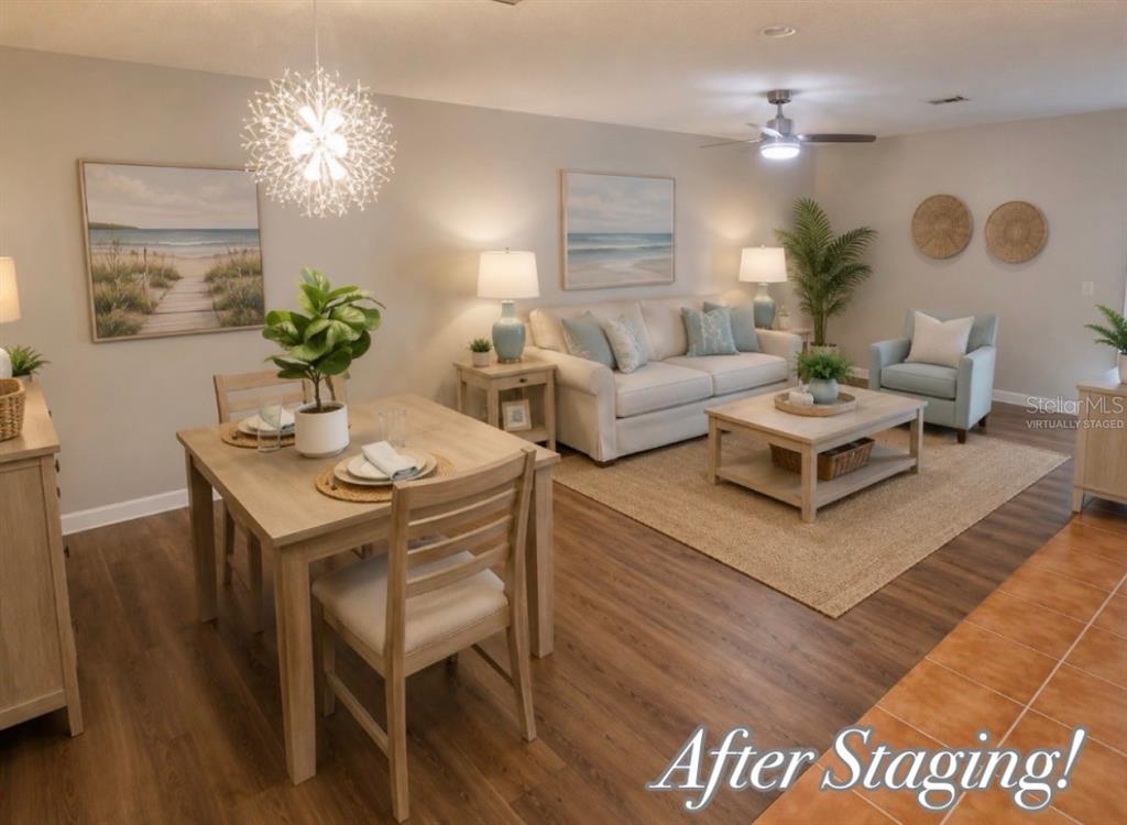 This virtually staged living and dining area features light wood furniture and coastal-themed wall art — 2954 PEACH STREET, LEESBURG, FL