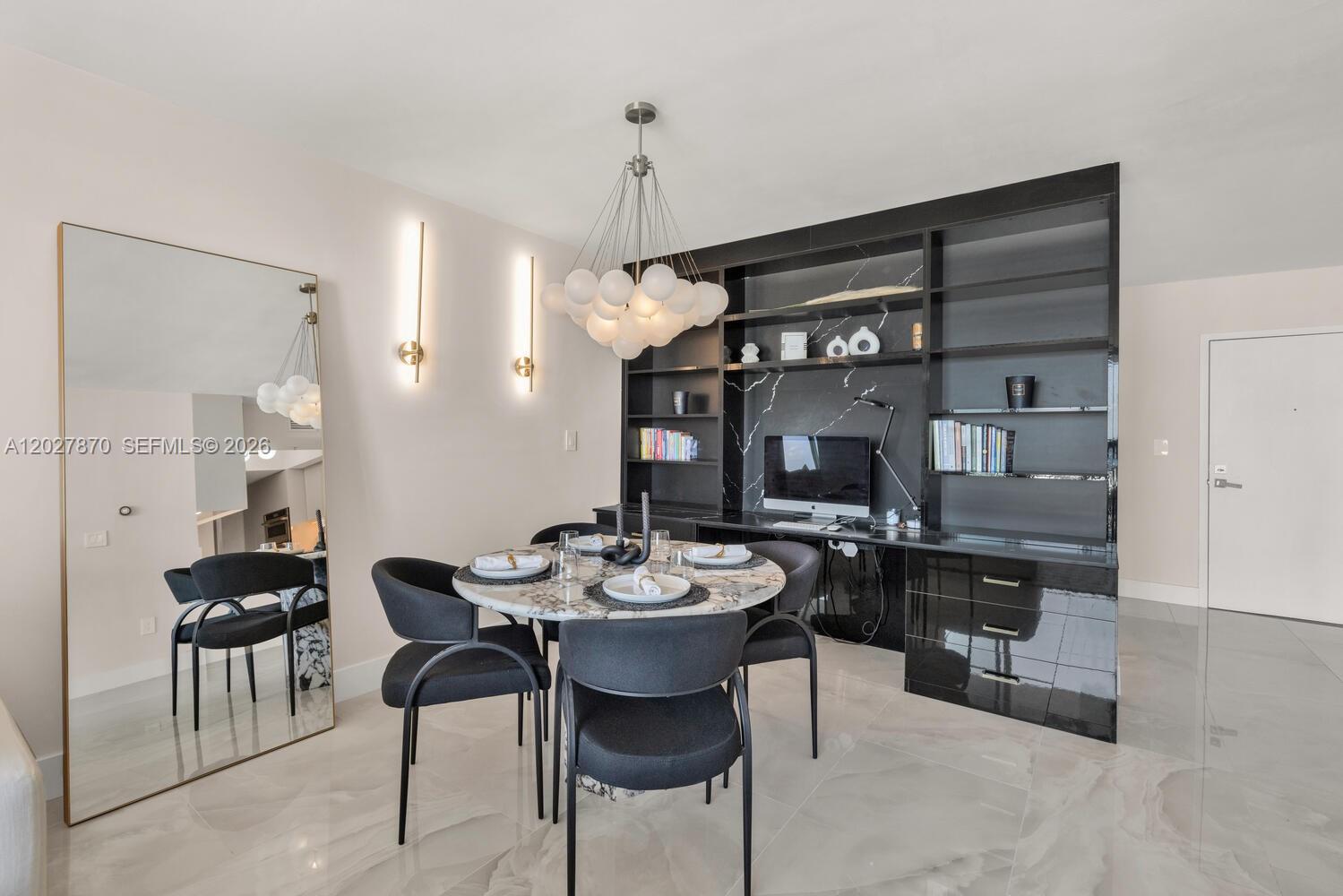 A dining room features a marble table, dark chairs, and a large black built-in unit — 90 Alton Rd # 2207, Miami Beach FL 33139, MIAMI BEACH, FL