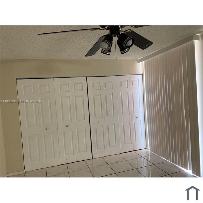 A room with white bi-fold closet doors, a ceiling fan, and vertical window blinds — 19791 SW 114th Ave # 331, Miami FL 33157, MIAMI, FL