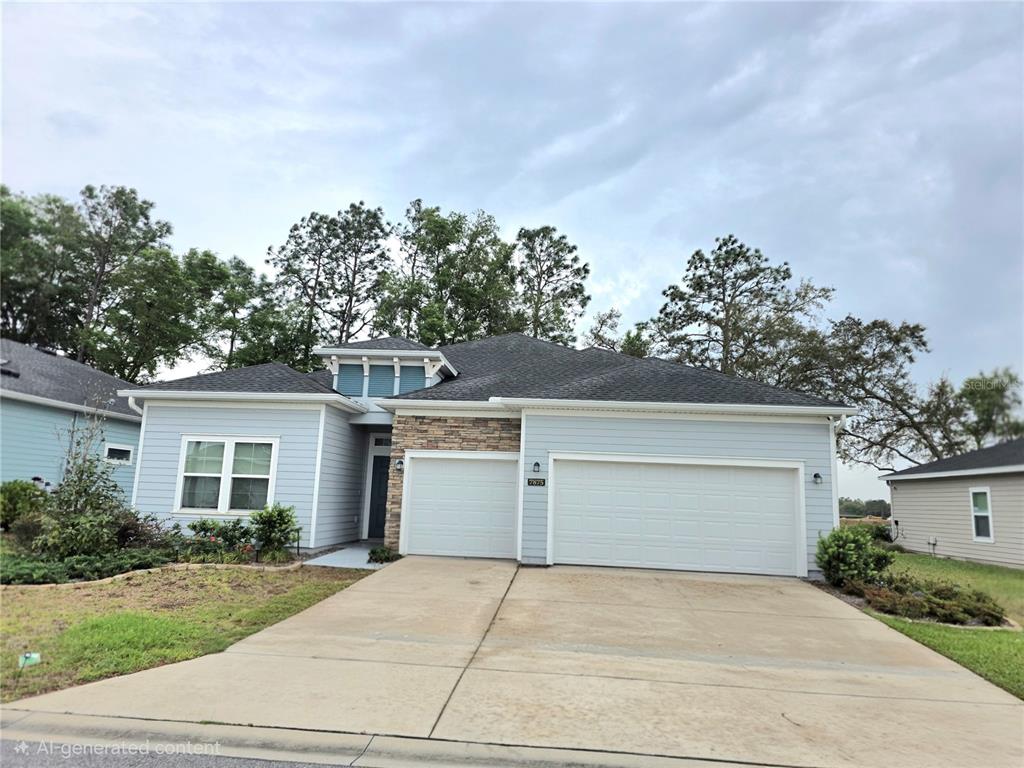 A single-story house with light blue siding, a stone accent wall, and a three-car garage — 7875 SW 74TH LOOP, OCALA, FL