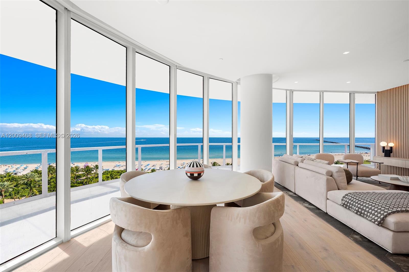 A dining area and living room feature floor-to-ceiling windows with panoramic ocean views — 100 S Pointe Dr # 1206, Miami Beach FL 33139, MIAMI BEACH, FL