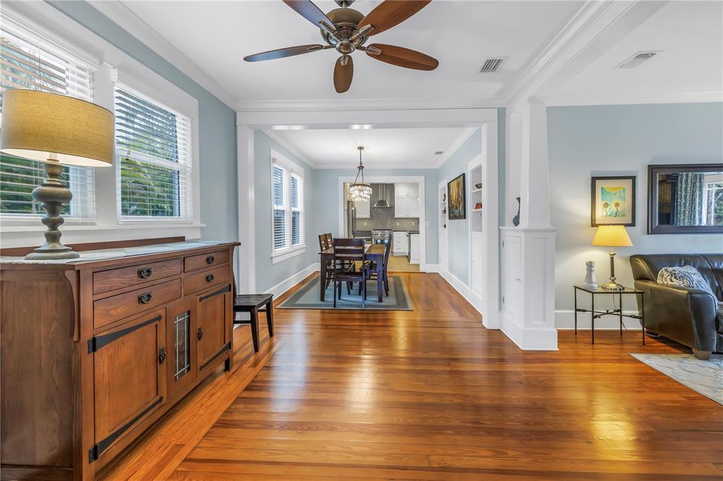 A living room features a dark leather sofa, two gray armchairs, and a wooden coffee table — 436 12TH AVENUE NE, ST PETERSBURG, FL