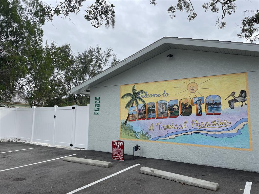 A parking lot sits in front of a building wall featuring a large Sarasota mural — 1912 MORRILL UNIT Lime, SARASOTA, FL