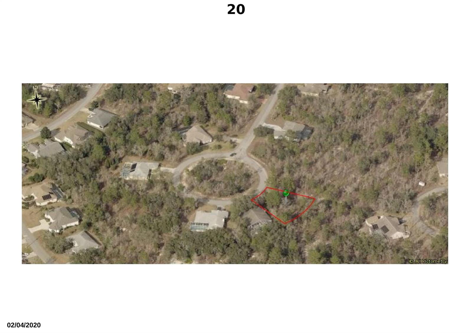 An aerial view shows a vacant, wooded lot outlined in red near a cul-de-sac — 20 Dahlia Court S, FL 34446, FL