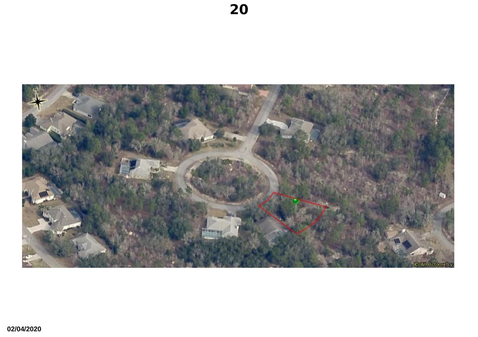 This aerial view shows a vacant, wooded residential lot outlined in red within a cul-de-sac — 20 Dahlia Court S, FL 34446, FL
