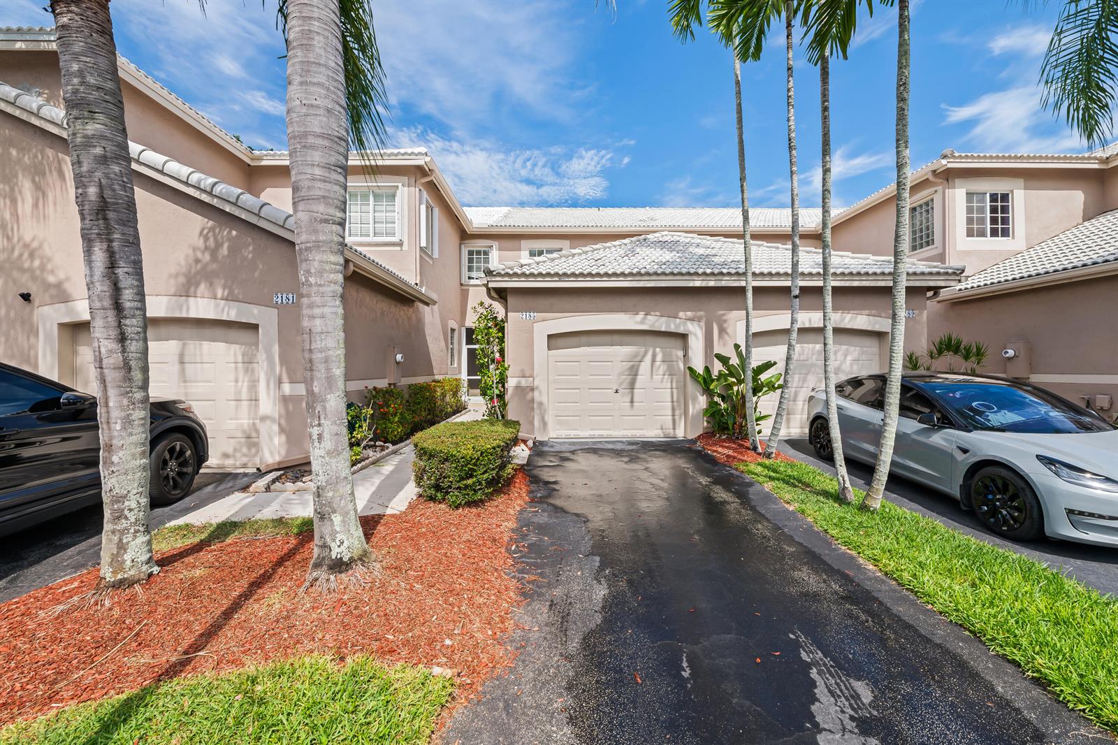 A multi-unit residential building features beige stucco walls, tiled roofs, and attached garages — 2185 Salerno Circle, Weston FL 33327, WESTON, FL