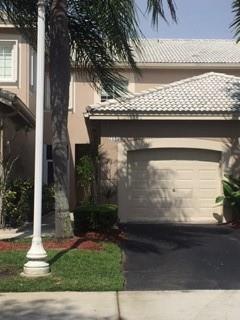A two-story house with a beige exterior, a single-car garage, and a palm tree — 2185 Salerno Circle, Weston FL 33327, WESTON, FL