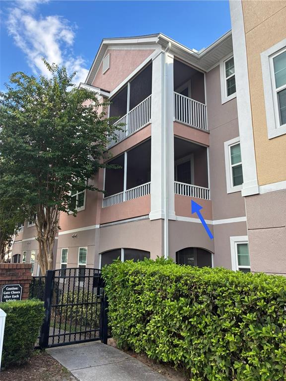 A multi-story apartment building exterior features screened-in balconies with white railings and stucco walls — 3315 PARKCHESTER SQUARE BOULEVARD UNIT 206, ORLANDO, FL