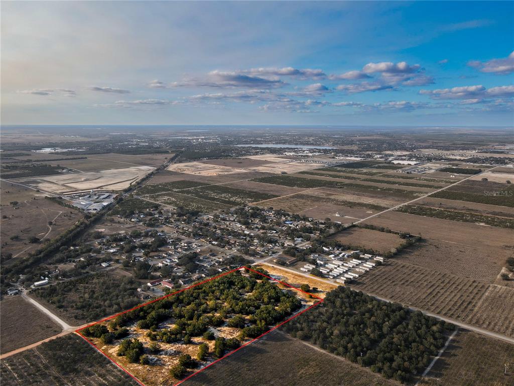 An aerial view shows a rectangular plot of land outlined in red near a residential area — LEWIS GRIFFIN ROAD, BABSON PARK, FL