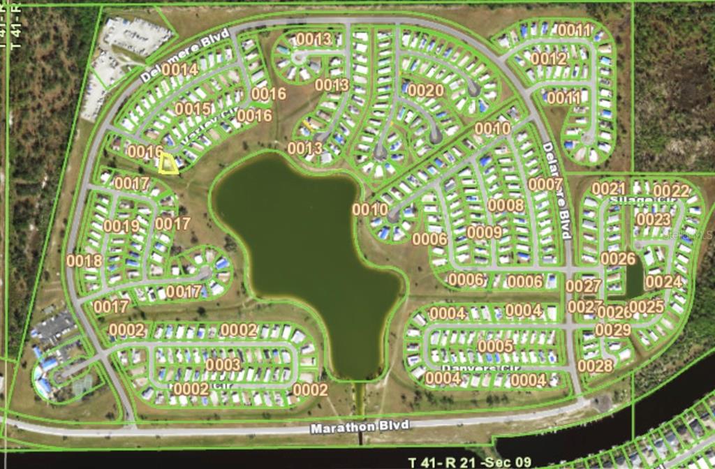 This is an aerial map showing a residential neighborhood layout surrounding a central lake — 7368 VARLEY CIRCLE, PORT CHARLOTTE, FL