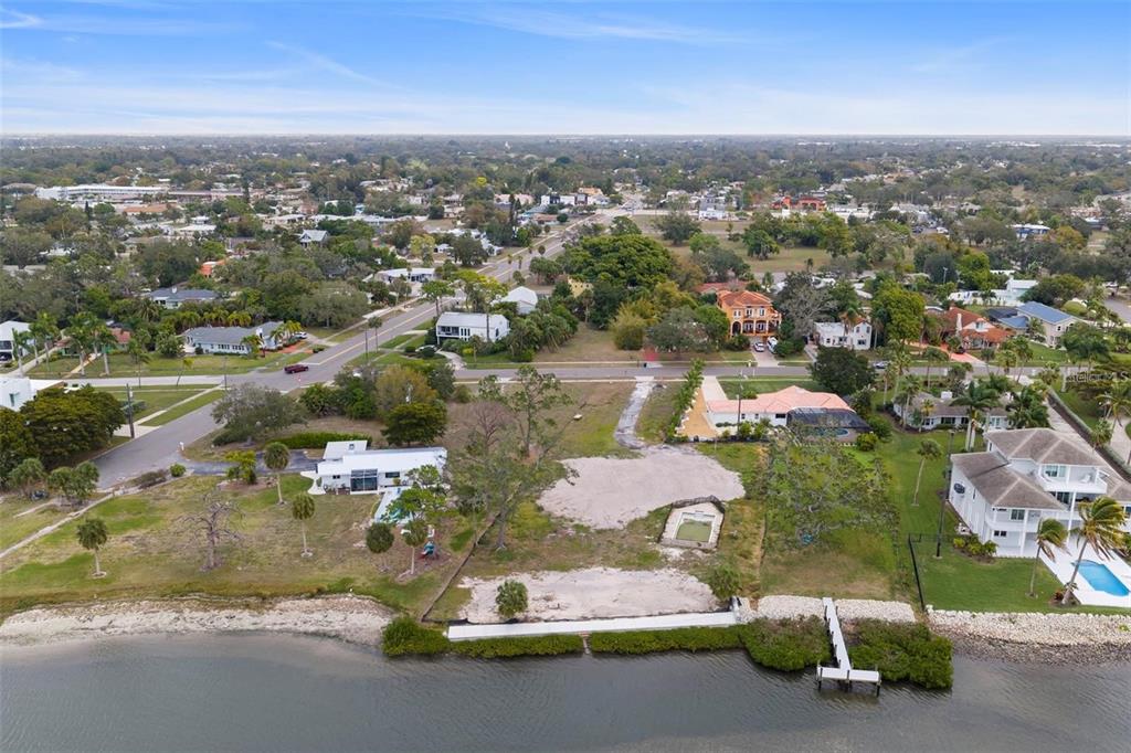 An aerial view shows a waterfront vacant lot situated between two residential properties — 7510 WESTMORELAND DRIVE, SARASOTA, FL
