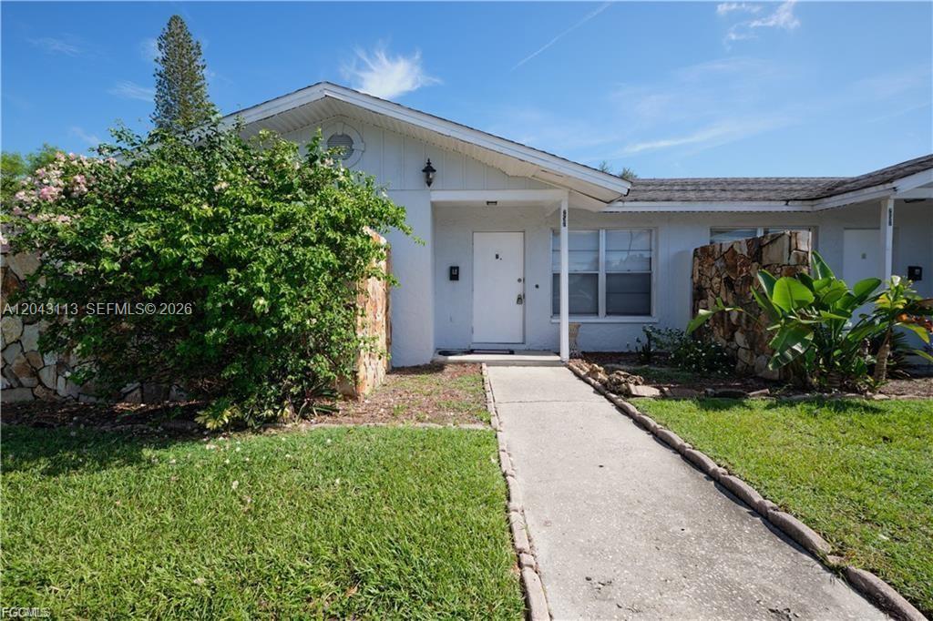 A single-story house with a white door, stone accents, and a concrete walkway — 257 CAPE CORAL PKY E # B, Cape Coral FL 33904, CAPE CORAL, FL