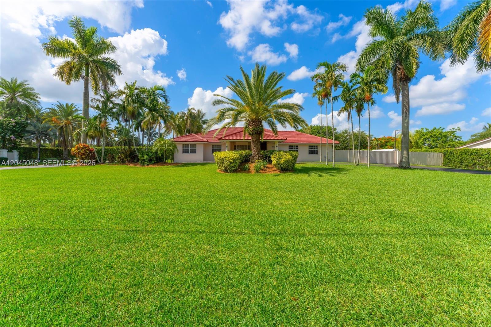 A single-story house with a metal roof and a paved driveway is shown in this rendering — 9900 SW 62nd St, Miami FL 33173, MIAMI, FL