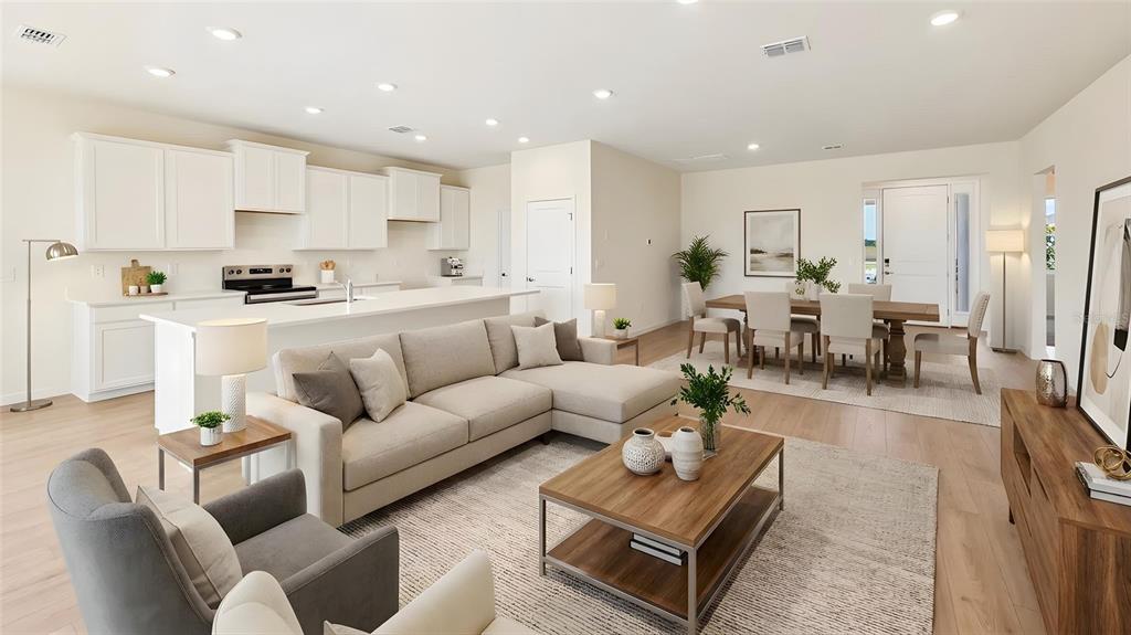 An open-concept living room and kitchen area with light wood floors and neutral furniture — 4550 NW 39TH STREET ROAD, OCALA, FL