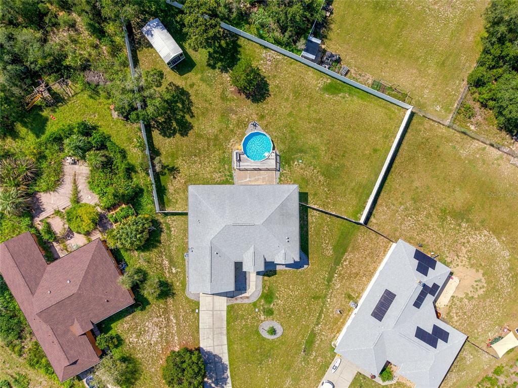 An aerial view shows a house with a fenced backyard, a pool, and a driveway — 10917 SW 45TH COURT, OCALA, FL