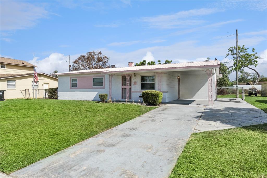 A single-story house with a white exterior, pink accents, and a concrete driveway — 3309 COLEMAN PLACE, ORLANDO, FL