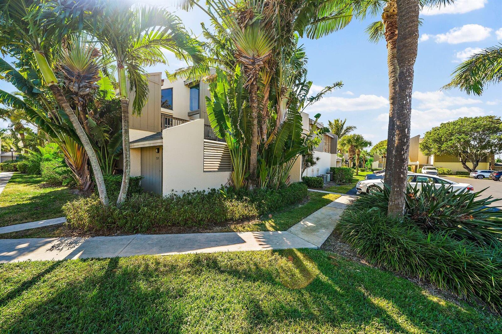 A multi-story residential building exterior surrounded by palm trees and a paved walkway — 1605 S Us Highway 1 # 5a, Jupiter FL 33477, JUPITER, FL