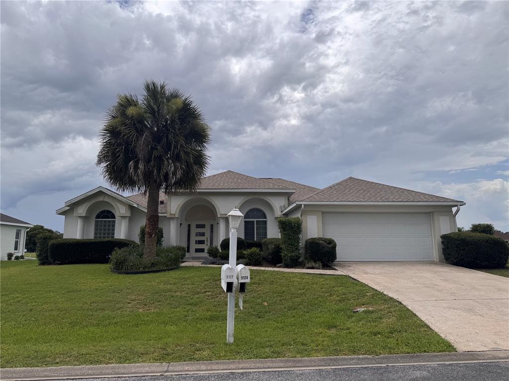 A single-story house with a palm tree, a two-car garage, and two mailboxes in front — 5126 NW 26TH STREET, OCALA, FL