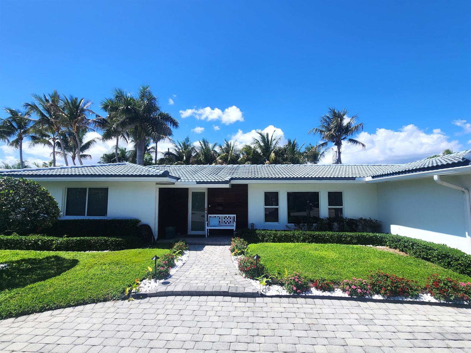 A single-story white house with a tiled roof, palm trees, and a paved walkway — 3481 NE 31st Avenue, Lighthouse Point FL 33064, LIGHTHOUSE POINT, FL