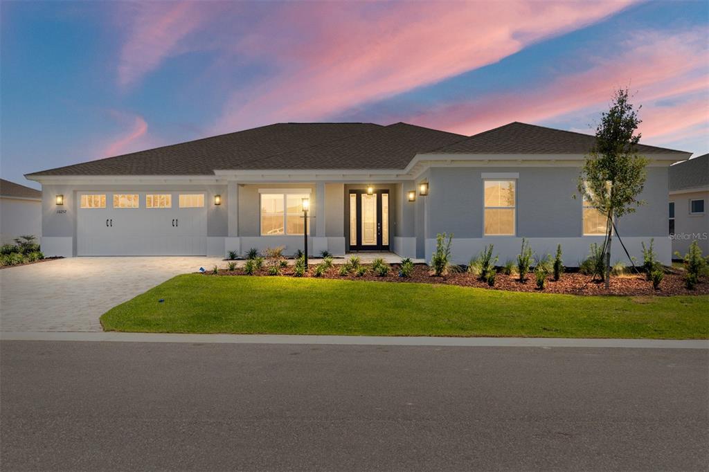 A single-story house with a gray exterior, a two-car garage, and a paved driveway — 10252 SW 85TH PLACE ROAD, OCALA, FL