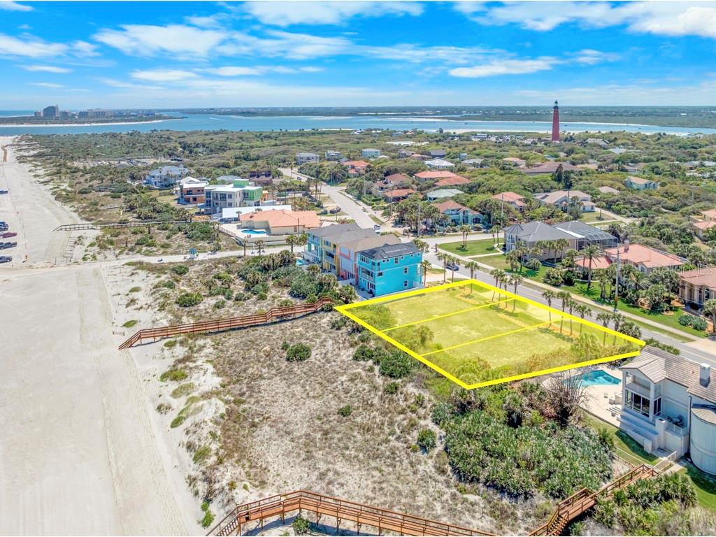 An aerial view shows a vacant, rectangular oceanfront lot outlined in yellow near a beach — 4873 S ATLANTIC AVENUE, PONCE INLET, FL
