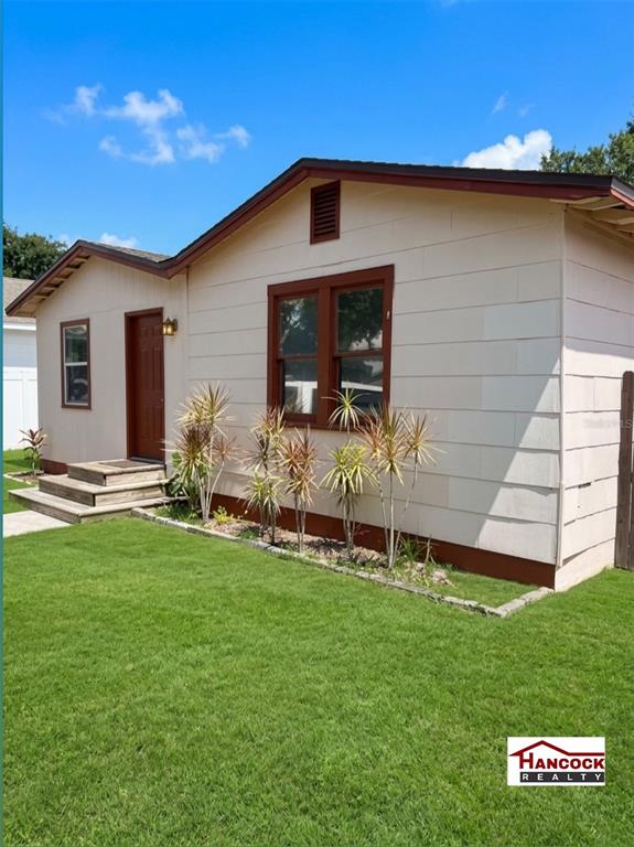 A single-story house with light-colored siding, brown trim, and a small wooden front porch — 4255 43RD AVENUE N, ST PETERSBURG, FL