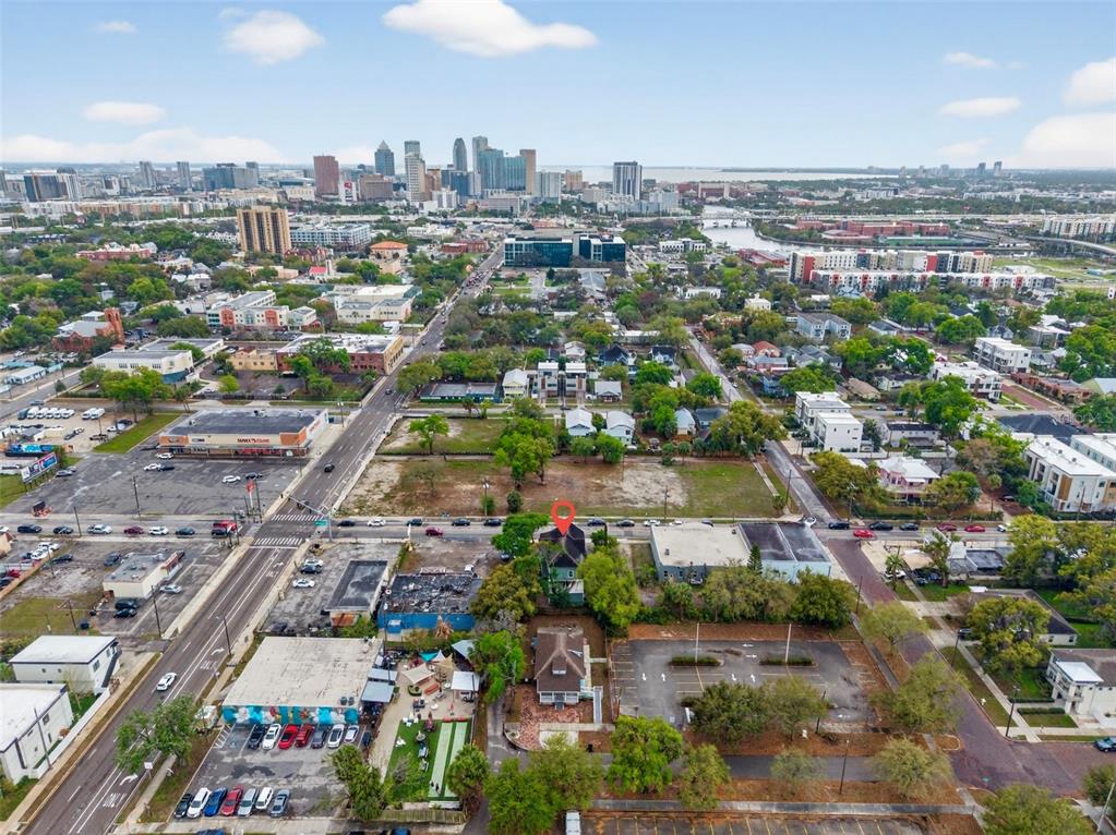 An aerial view shows a house with a red location pin in an urban area — 105 W COLUMBUS DRIVE, TAMPA, FL