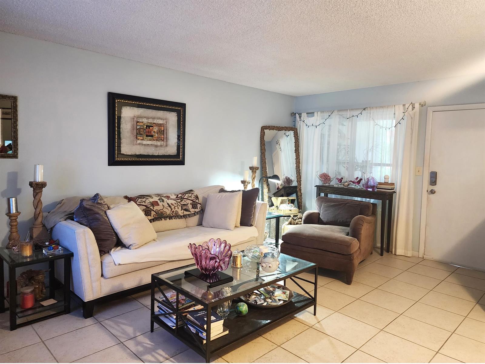 A living room features a beige sofa, a glass coffee table, and a brown armchair — 804 SE 7th Street # 101, Deerfield Beach FL 33441, DEERFIELD BEACH, FL