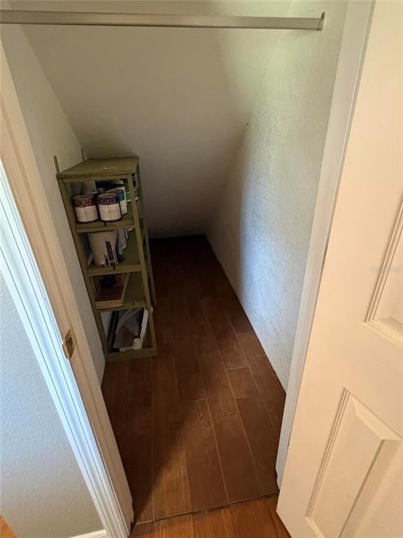 A small closet with wood-look tile flooring and a green metal shelving unit — 2 FT CLINCH HEIGHTS ROAD, FROSTPROOF, FL