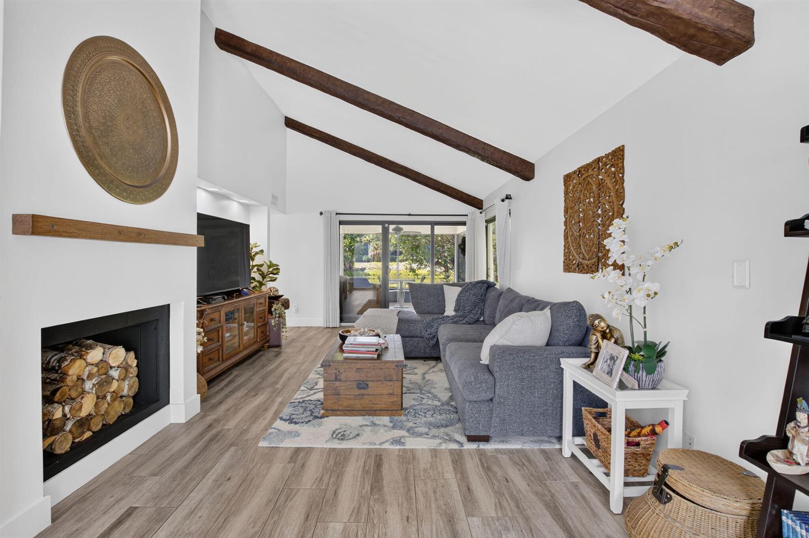 A living room features a fireplace, vaulted ceiling with wood beams, and a sectional sofa — 5918 Patio Drive, Boca Raton FL 33433, BOCA RATON, FL