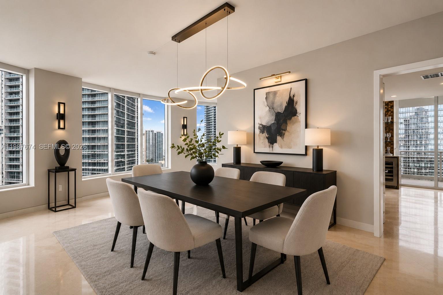 A modern dining room features a dark wood table, upholstered chairs, and a sculptural light fixture — 901 Brickell Key Blvd # 2804, Miami FL 33131, MIAMI, FL