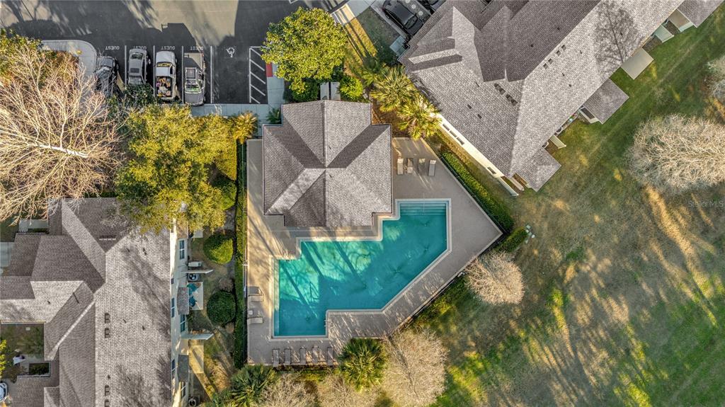 An aerial view shows a swimming pool, a pool house, and surrounding residential buildings — 2916 ROYAL TUSCAN LANE, VALRICO, FL