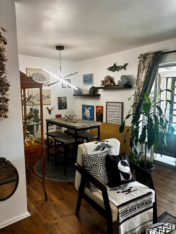 A dining area with a modern light fixture, high-top table, and an adjacent armchair — 1180 PASEO DEL MAR UNIT C, CASSELBERRY, FL
