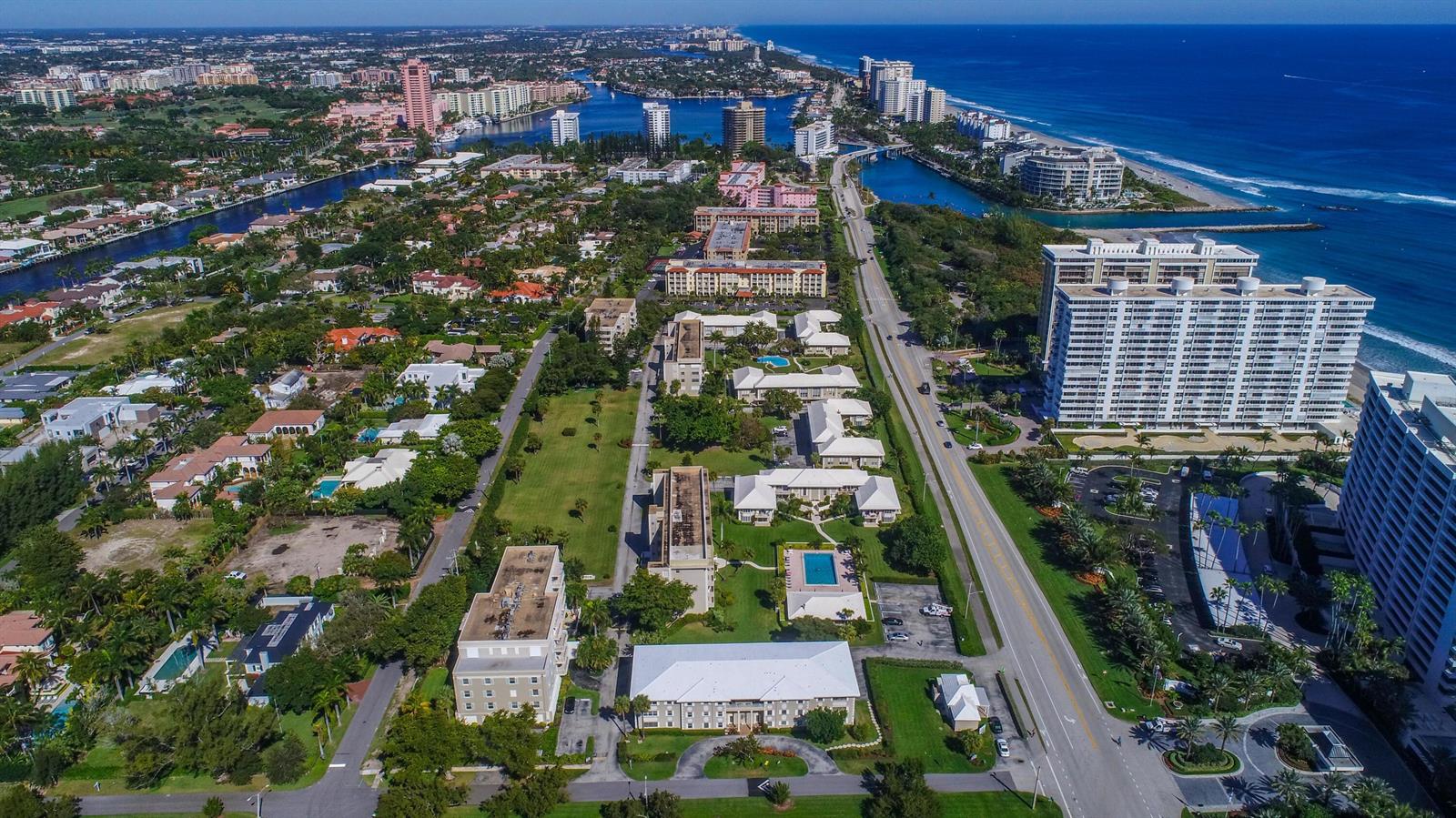 Aerial view of a coastal residential area with apartment buildings, a road, and the ocean — 950 De Soto Road # 2b, Boca Raton FL 33432, BOCA RATON, FL