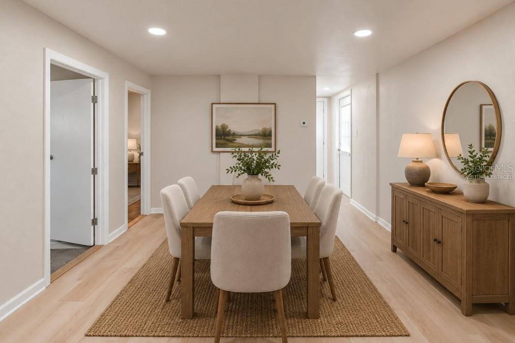 A dining room features a wooden table, six upholstered chairs, a sideboard, and light flooring — 16137 LAUDERDALE STREET, BROOKSVILLE, FL