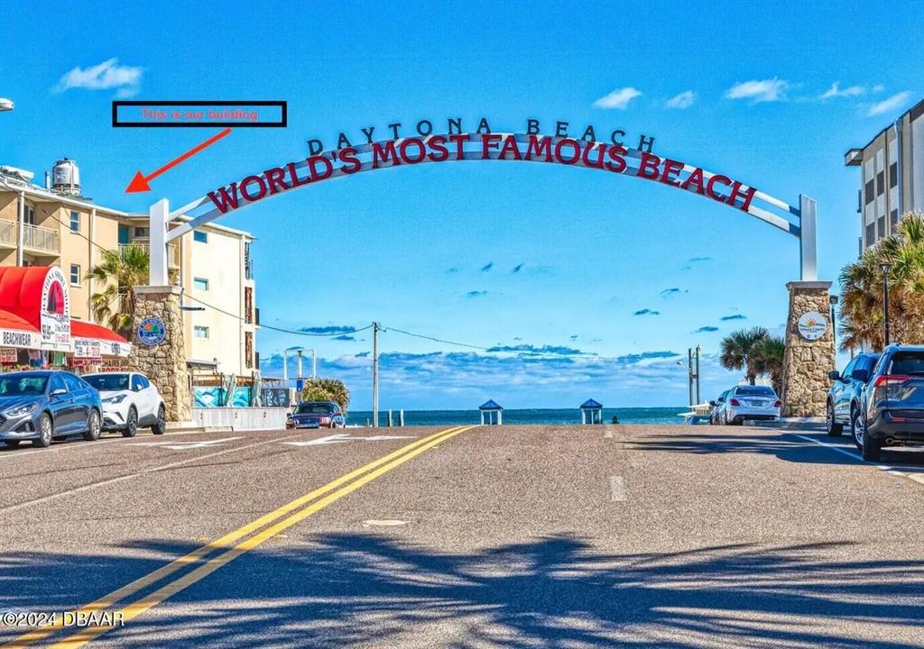 An exterior view of a street leading to the ocean under a Daytona Beach archway — 219 S ATLANTIC AVENUE UNIT 308, DAYTONA BEACH, FL